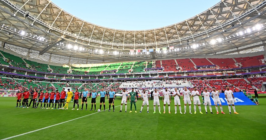 epa09614478 The teams of Egypt (L) and Lebanon line up for the national anthems before kick-off of the FIFA Arab Cup group D soccer match between Egypt and Lebanon in Doha, Qatar, 01 December 2021. EP ...