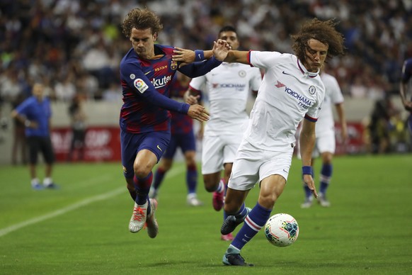 Chelsea&#039;s David Luiz, right, and Barcelona&#039;s Antoine Griezmann, left, vie for the ball during their friendly soccer match in Saitama, north of Tokyo, Tuesday, July 23, 2019. (AP Photo/Eugene ...