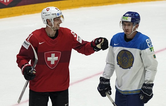 Fabrice Herzog of Switzerland, left, celebrates after scoring his side&#039;s third goal beside Kazakhstan&#039;s Anton Sagadeyev during the group A Hockey World Championship match between Switzerland ...