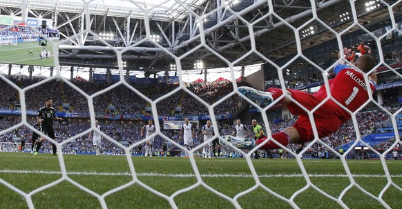 Iceland goalkeeper Hannes Halldorsson, right, saves a penalty by Argentina&#039;s Lionel Messi during the group D match between Argentina and Iceland at the 2018 soccer World Cup in the Spartak Stadiu ...