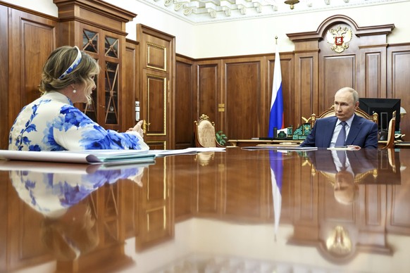 Russian President Vladimir Putin, right, speaks with the Presidential Commissioner for Children&#039;s Rights Maria Lvova-Belova during their meeting at the Kremlin, in Moscow, Russia, Monday, June 2, ...