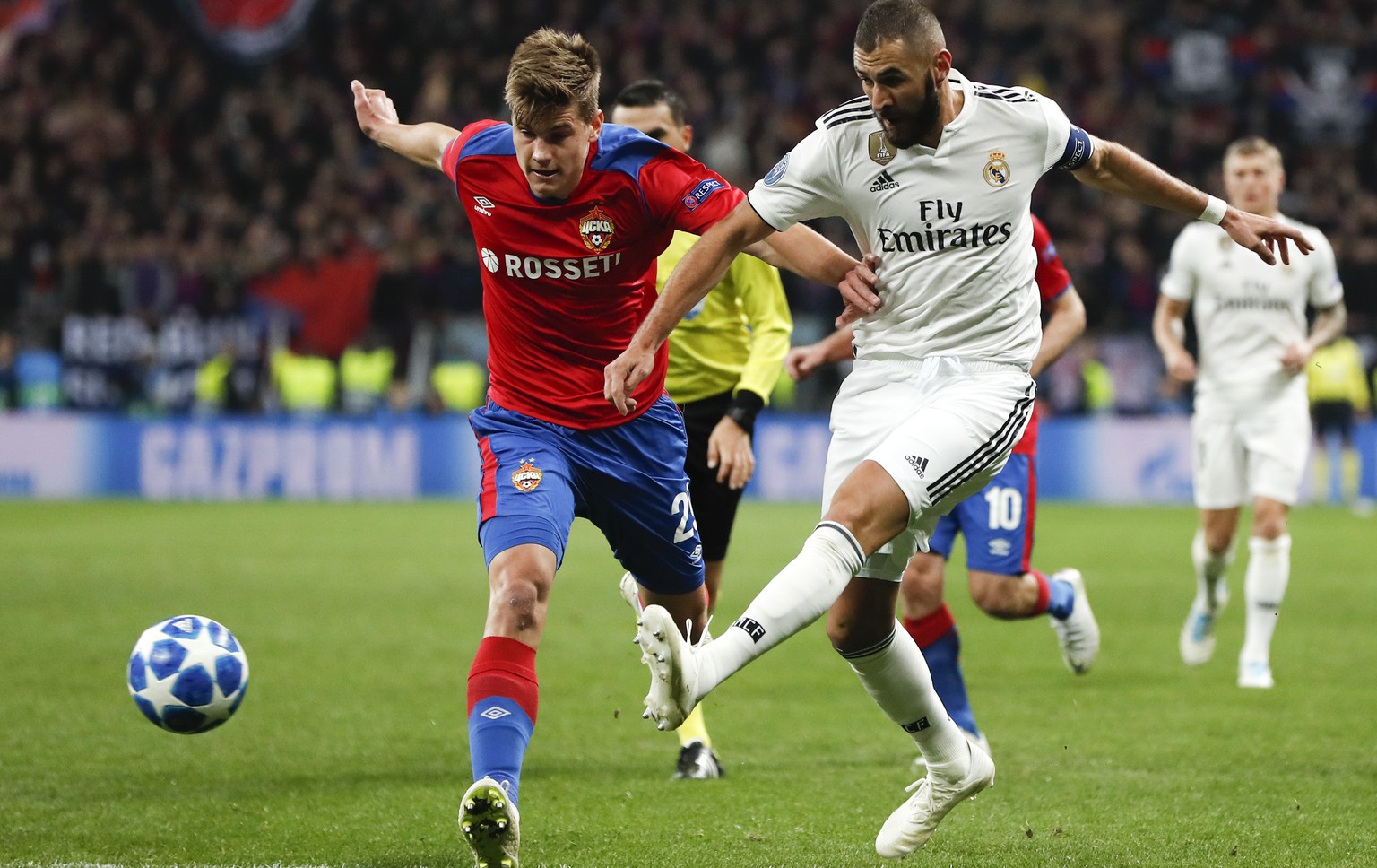 Real forward Karim Benzema, right, and CSKA midfielder Jaka Bijol challenge for the ball during a Group G Champions League soccer match between CSKA Moscow and Real Madrid at the Luzhniki Stadium in M ...