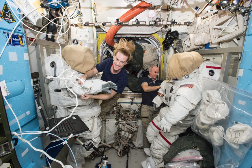 epa05501540 An undated handout picture made available by NASA on 20 August 2016 shows International Space Station (ISS) Expedition 48 crew members Kate Rubins (L) and Jeff Williams (R) outfitting spac ...