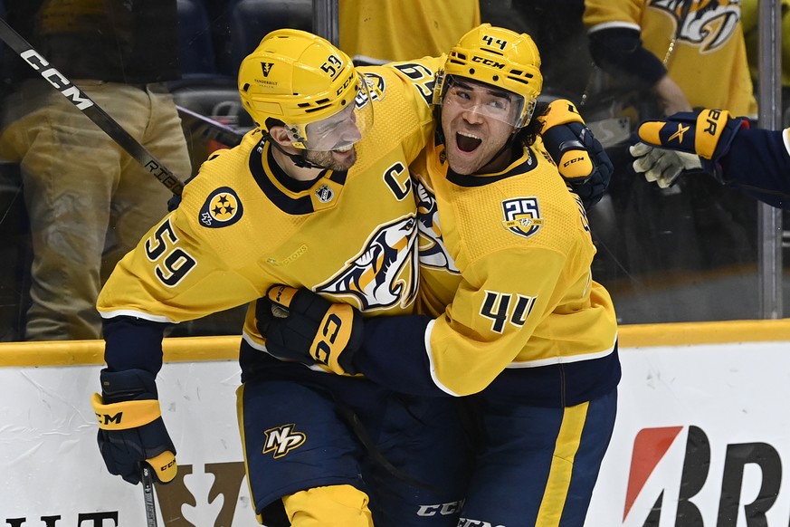 Nashville Predators defenseman Roman Josi (59) celebrates with left wing Kiefer Sherwood (44) after Josi scored a goal against the Winnipeg Jets after during the second period of an NHL hockey game, S ...