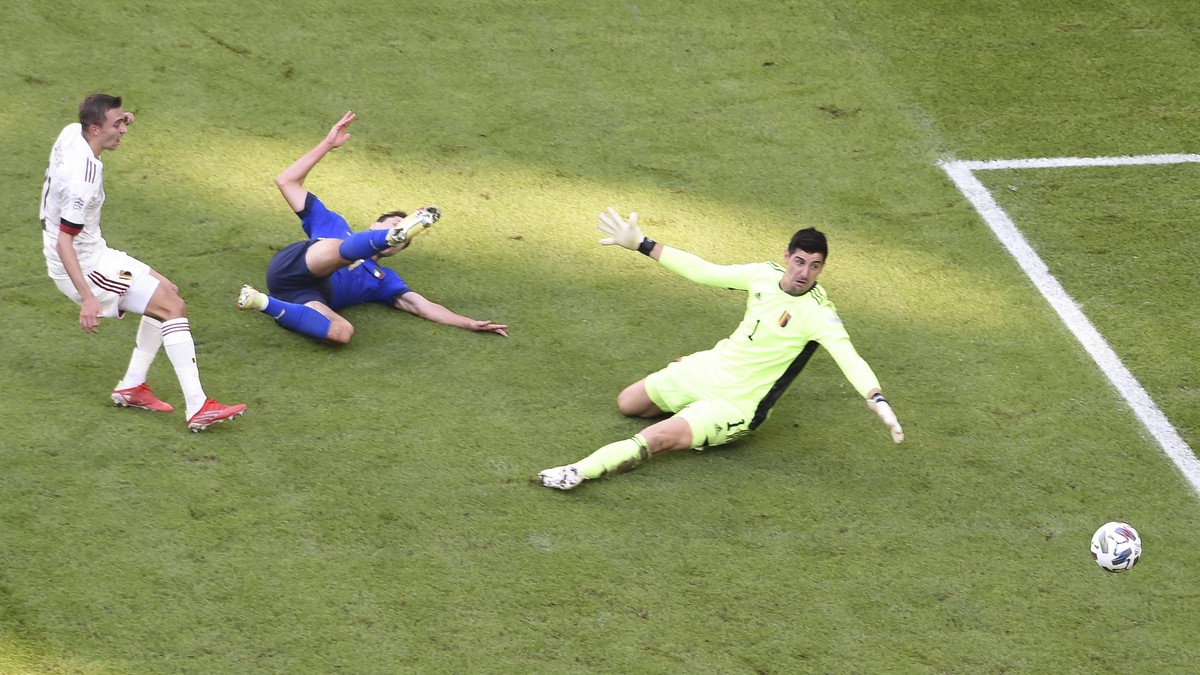 epa09516681 Federico Chiesa (C) of Italy in action against Thibaut Courtois (R) of Belgium during the UEFA Nations League third place soccer match between Italy and Belgium in Turin, Italy, 10 October ...