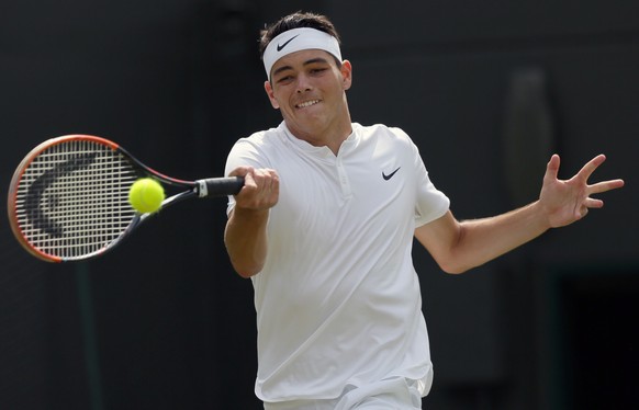 Taylor Fritz of the U.S plays a return to Stan Wawrinka of Switzerland during their men&#039;s singles match on day two of the Wimbledon Tennis Championships in London, Tuesday, June 28, 2016. (AP Pho ...