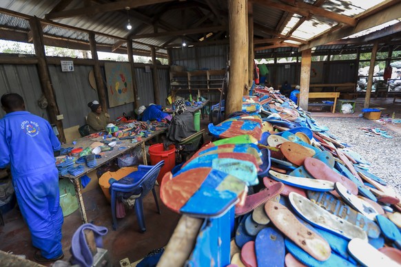 epa10228982 Kenyan workers from the social enterprise &#039;Ocean sole&#039; sort and prepare old flip-flops as preparation for processing them into art pieces at their workshop in Nairobi, Kenya, 06  ...