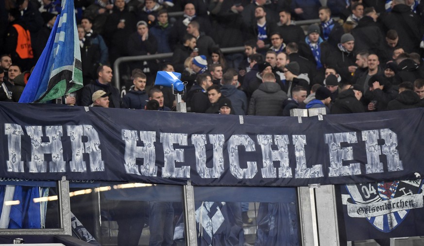 Schalke supporters show a banner reading &#039;you hypocrite&#039; prior the German soccer cup, DFB Pokal, quarter-final match between FC Schalke 04 and Bayern Munich in Gelsenkirchen, Germany, Tuesda ...