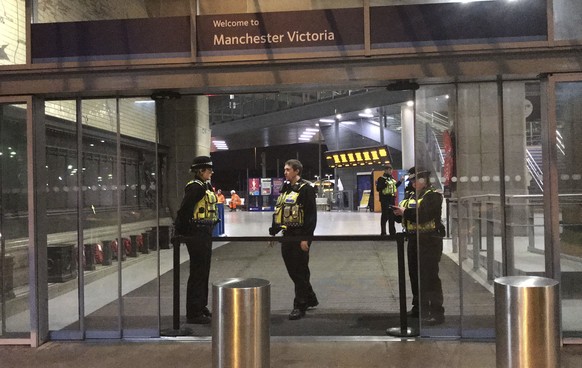 Police at Victoria Station in Manchester, England, late Monday Dec. 31, 2018 after a man had stabbed three people. Two commuters - a man and woman in their 50s - were taken to hospital with knife inju ...