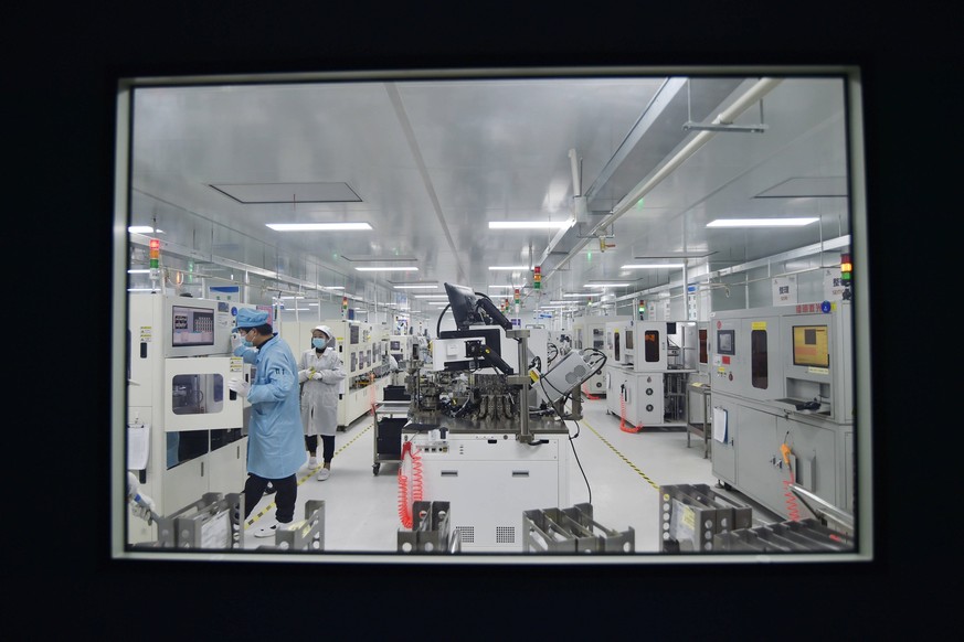 SUQIAN, CHINA - FEBRUARY 28: An employee works on the production line of chips at a dust-free workshop of a semiconductor factory on February 28, 2023 in Suqian, Jiangsu Province of China. PUBLICATION ...