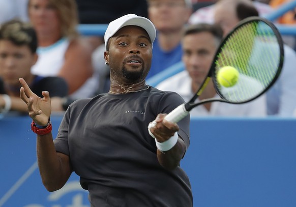 Donald Young returns against Stan Wawrinka of Switzerland during the first round of the Citi Open tennis tournament, Tuesday, July 31, 2018, in Washington. (AP Photo/Carolyn Kaster)