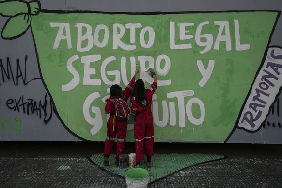 FILE - In this Sept. 28, 2021 file photo, abortion-rights demonstrators paint a mural that reads in Spanish; &quot;Legal, free and safe abortion,&quot; during a Global Day of Action for access to lega ...