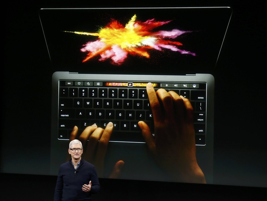 Apple CEO Tim Cook speaks under a graphic of the new MacBook Pro during an Apple media event in Cupertino, California, U.S. October 27, 2016. REUTERS/Beck Diefenbach TPX IMAGES OF THE DAY