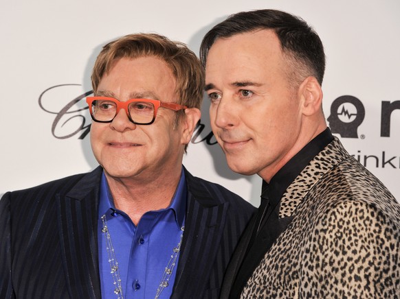 Elton John, left, and David Furnish arrive at the 2014 Elton John Oscar Viewing and After Party on Sunday, March 2, 2014, in West Hollywood, Calif. (Photo by Richard Shotwell/Invision/AP)