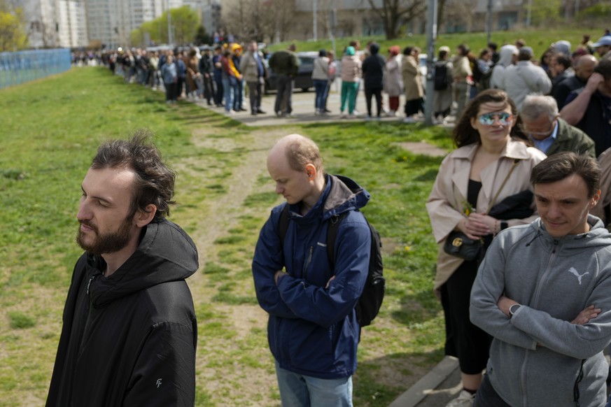People queue to vote outside a polling station set up in a Russian school in Belgrade, Serbia, Sunday, March 17, 2024. Russians at home and abroad are heading to the polls for a presidential election  ...
