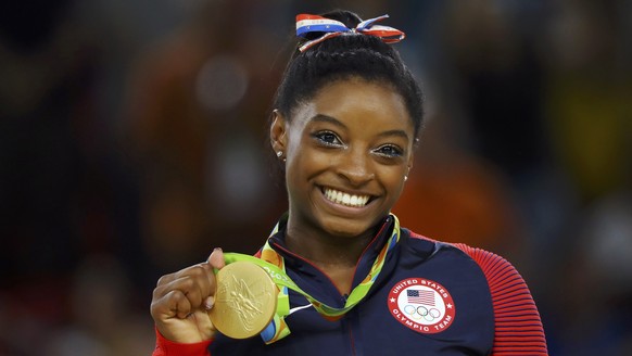 2016 Rio Olympics - Artistic Gymnastics - Victory Ceremony - Women&#039;s Floor Victory Ceremony - Rio Olympic Arena - Rio de Janeiro, Brazil - 16/08/2016. Simone Biles (USA) of USA poses with her gol ...