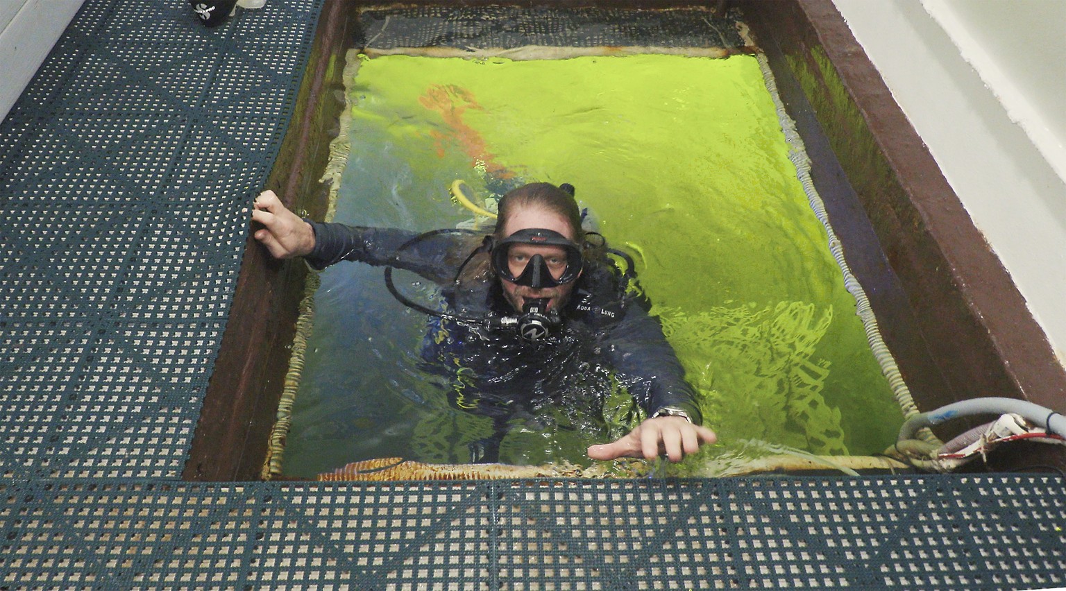 In this photo provided by the Florida Keys News Bureau, Dr. Joseph Dituri enters the Jules&#039; Undersea Lodge marine habitat 30 feet below the surface Wednesday, March 1, 2023, in Key Largo, Fla., t ...