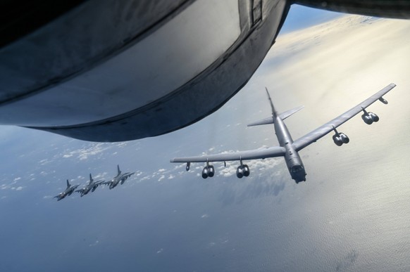 July 22, 2023, Pacific Ocean, Japan: A U.S. Air Force B-52 Stratofortress strategic bomber approaches to refuel from a KC-135 Stratotanker as three Japan Air Self-Defense Force F-2 Viper Zero fighter  ...