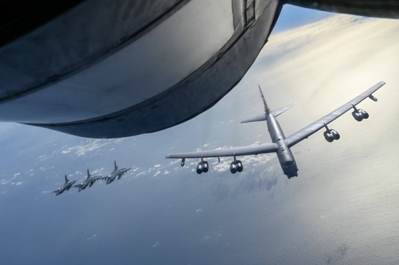 July 22, 2023, Pacific Ocean, Japan: A U.S. Air Force B-52 Stratofortress strategic bomber approaches to refuel from a KC-135 Stratotanker as three Japan Air Self-Defense Force F-2 Viper Zero fighter  ...