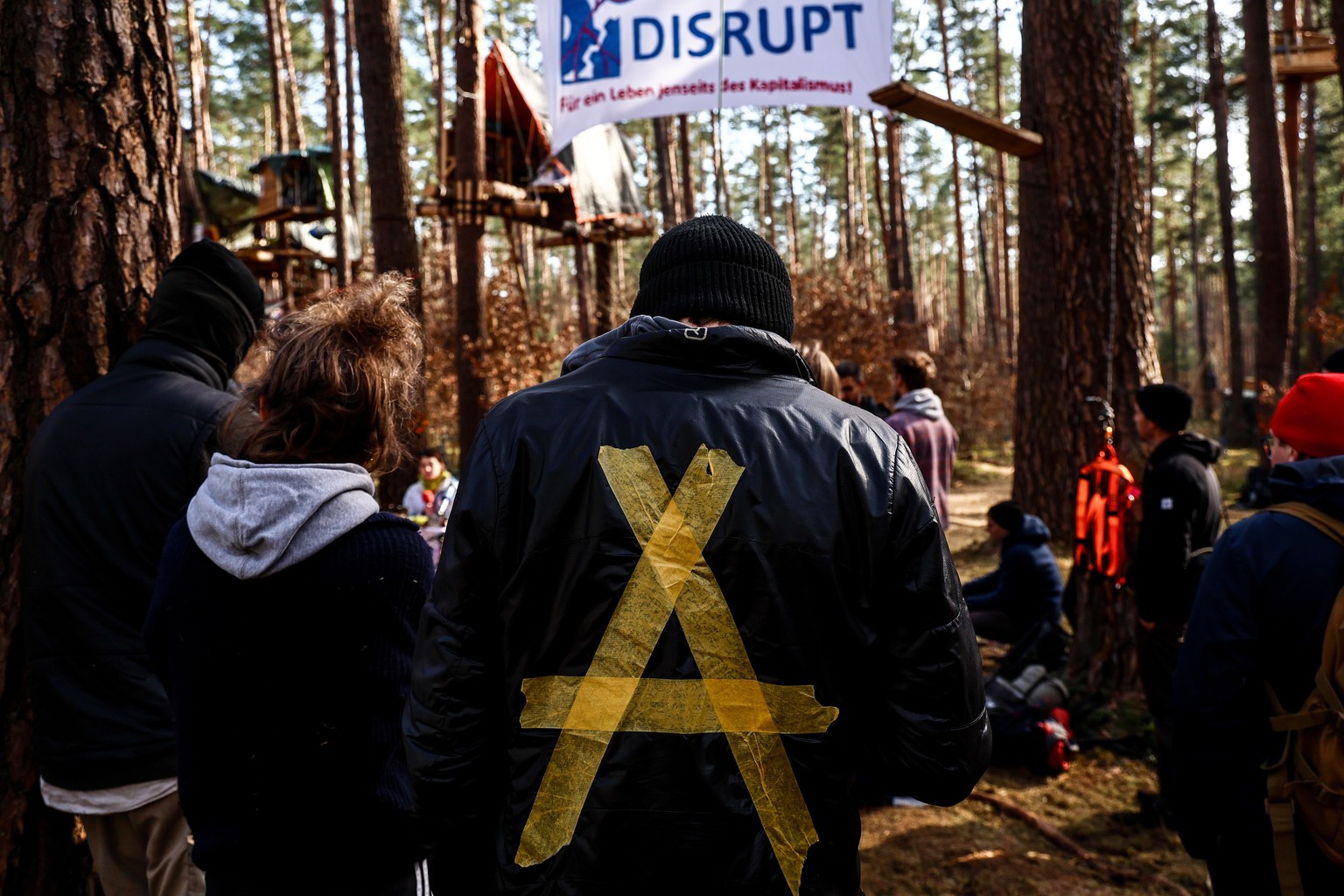 epa11229492 Environmental activists attend a protest by environmental activists against plans to cut down the forest to extend the Tesla Gigafactory, in Gruenheide, near Berlin, Germany, 19 March 2024 ...