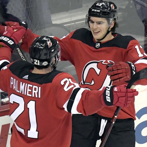 New Jersey Devils center Nico Hischier (13) celebrates his goal with right wing Kyle Palmieri (21) during the third period of an NHL hockey game against the Carolina Hurricanes on Thursday, Feb. 15, 2 ...