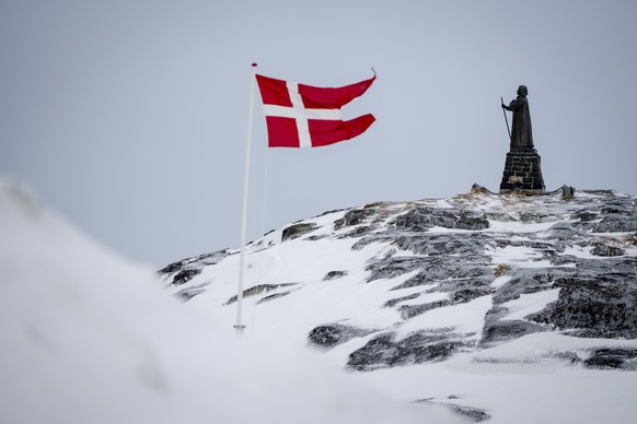 epa11953191 A view of the Dannebrog and Hans Egede Statue in Nuuk, Greenland, 09 March 2025 (issued 10 March 2025). Greenlanders are holding elections for Greenland&#039;s parliament, Inatsisartut, on ...