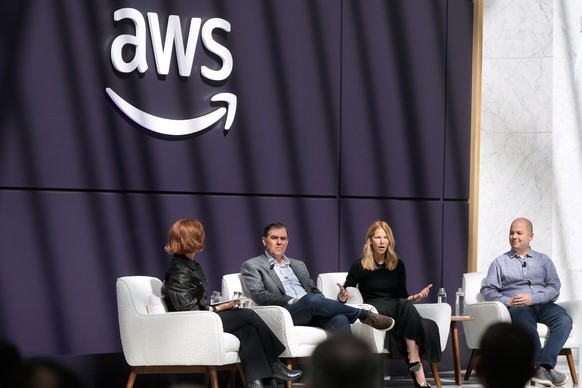 Denise Dresser, chief revenue officer of OpenAI, second right, speaks on stage with Julia White, vice president &amp; chief marketing officer, AWS, from left, Matt Garman, CEO of AWS, and Anthony Ligu ...