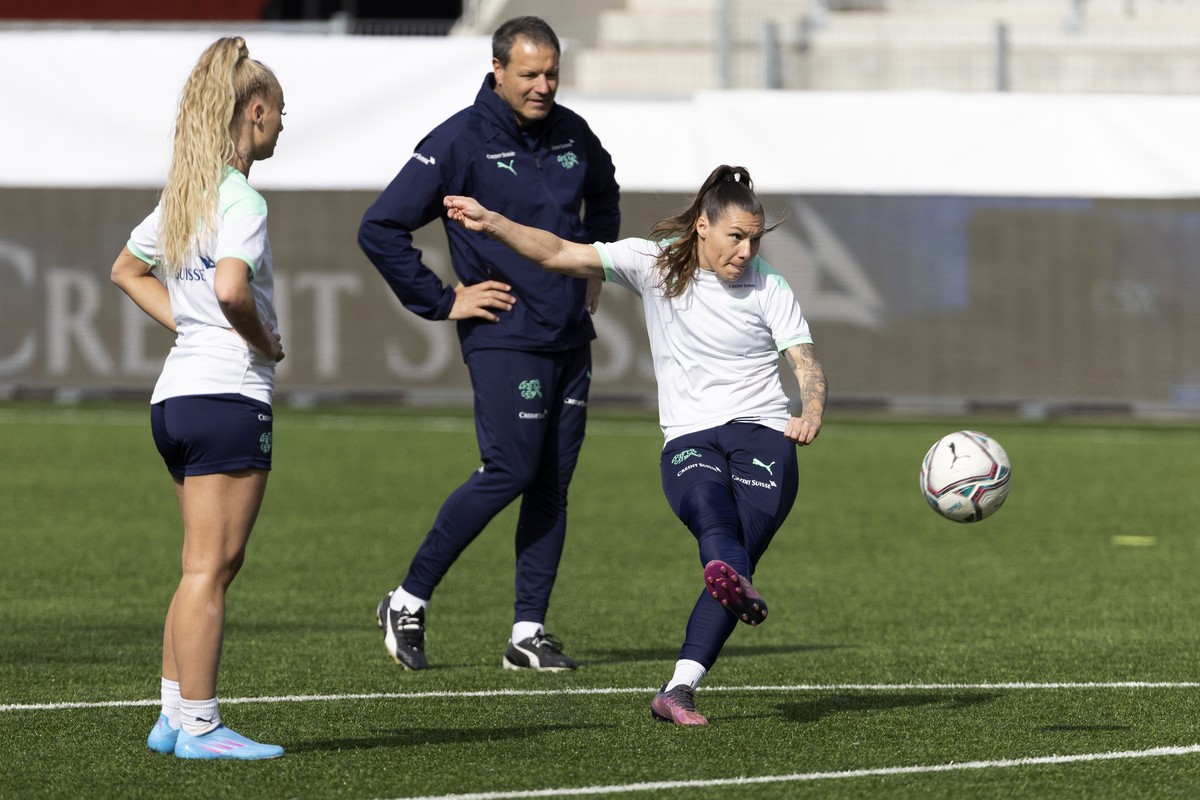Switzerland's Ramona Bachmann, right, in action beside teammate Alisha Lehmann, left, and assistant coach Michel Kohler, during a training session one day ahead of the FIFA Women's World Cup ...