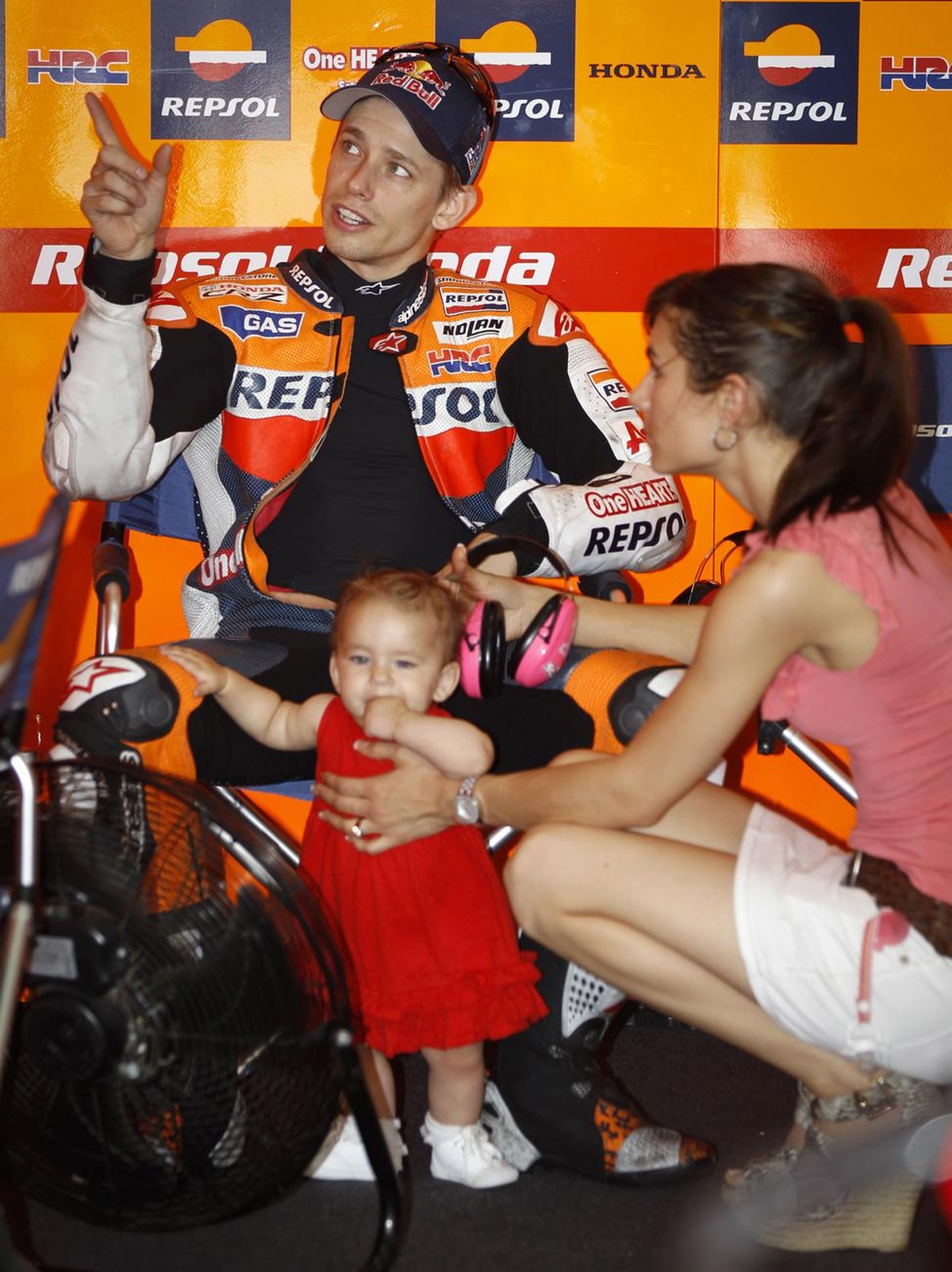Australia's Casey Stoner chats with his family before the MotoGP free practice session at the Malaysian Motorcycle Grand Prix in Sepang, Malaysia, Friday, Oct. 19, 2012. (AP Photo/ Vincent Thian)