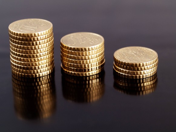 Coin stacks Stacks of 10 cents euros on a reflective black surface PUBLICATIONxINxGERxSUIxAUTxONLY Copyright: xldambiesx 767052
