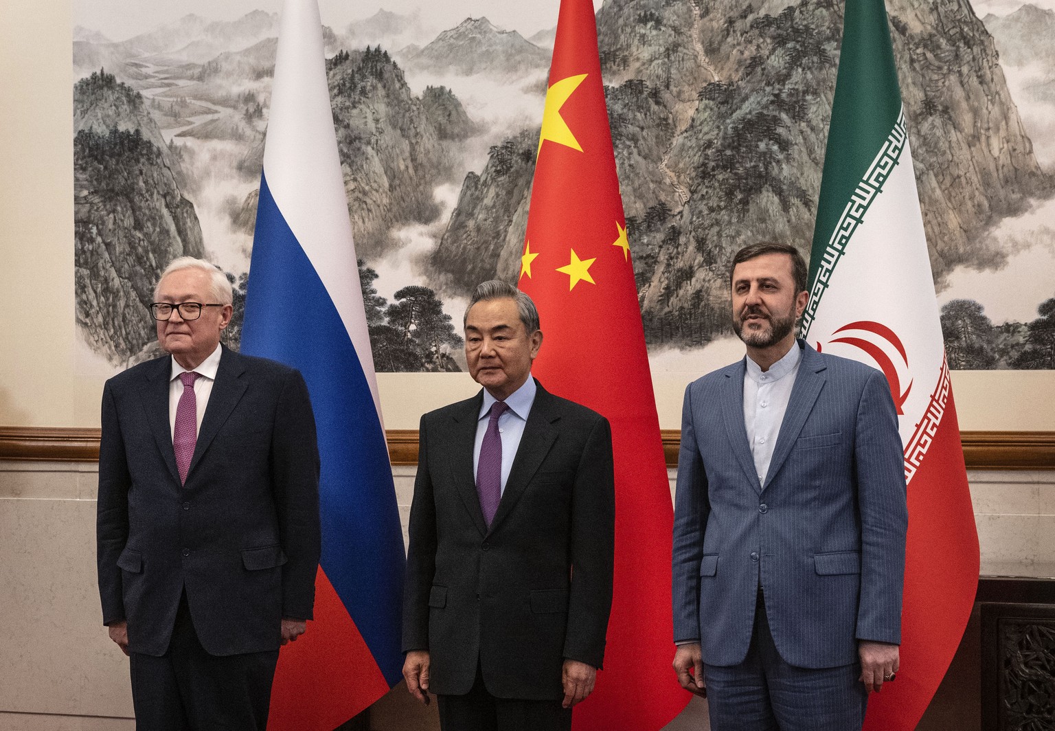 Chinese Foreign Minister Wag Yi, stands with Russian Deputy Foreign Minister Sergey Ryabkov, left, and Iranian Deputy Foreign Minister Kazeem Gharibabadi, right, before a meeting regarding the Iranian ...