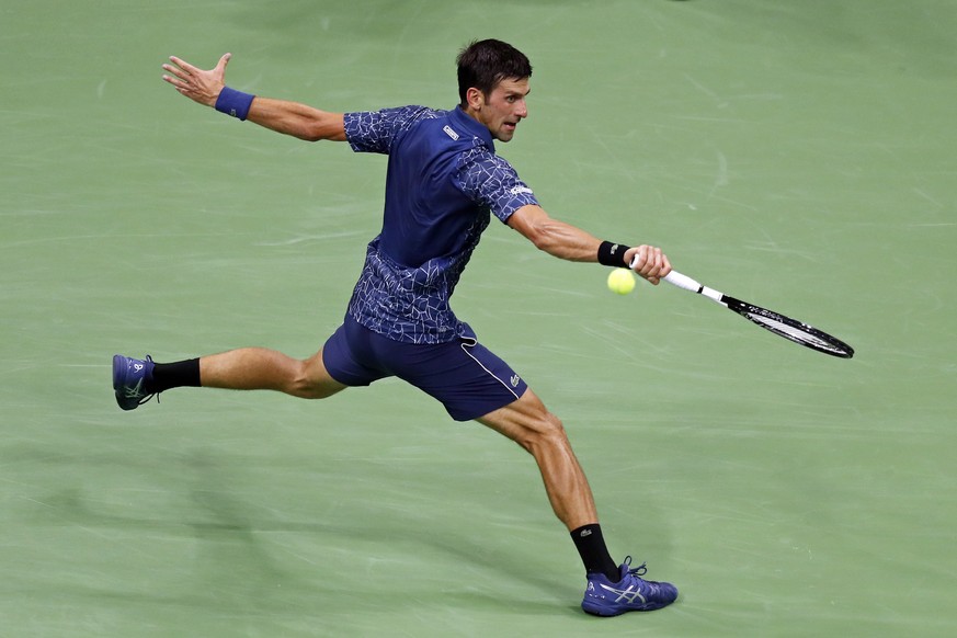 Novak Djokovic, of Serbia, reaches for a shot from John Millman, of Australia, during the quarterfinals of the U.S. Open tennis tournament Wednesday, Sept. 5, 2018, in New York. (AP Photo/Adam Hunger)