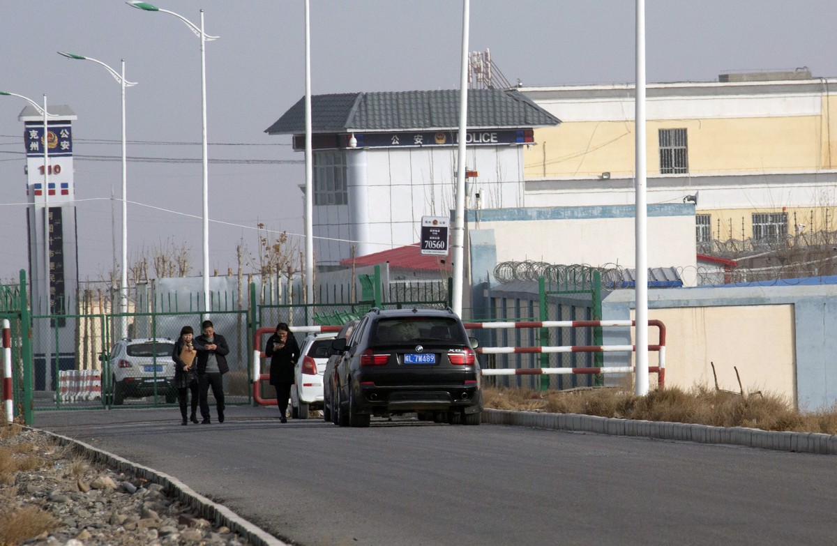 FILE - In this Dec. 3, 2018, file photo, people walk by a police station by the front gate of the Artux City Vocational Skills Education Training Service Center in Artux in western China's Xinjia ...