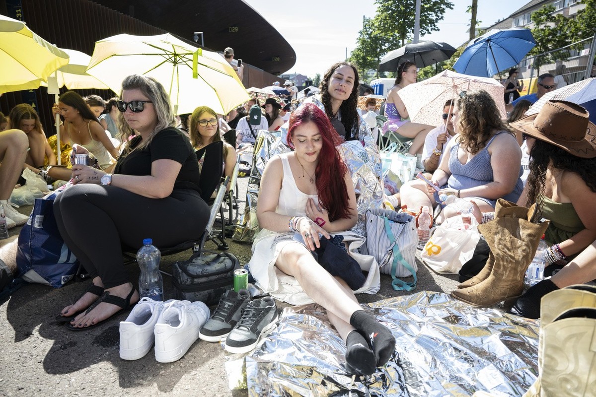 Fans also known as Swifties wait to attend the concert of US singer and songwriter Taylor Swift as part of her 'Eras Tour' in the front of the Letzigrund Stadium in Zurich, Switzerland, on 9 ...