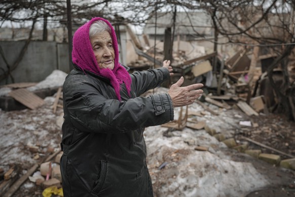 Valentyna Melnychenko gestures as she speaks to members of the Joint Centre for Control and Coordination on ceasefire of the demarcation line, or JCCC, surveying damage to her home from an artillery s ...