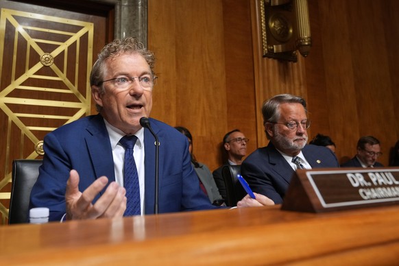 Committee Chairman Sen. Rand Paul, R-Ky., left, sitting next to ranking member Sen. Gary Peters, D-Mich., speaks as Dr. Anthony Fauci appears before the Senate Homeland Security and Governmental Affai ...