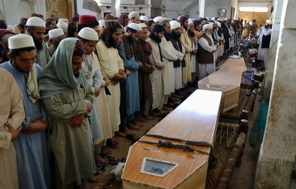 epa08778391 Relatives and people attend the funeral ceremony of victims who were killed in blast at an Islamic seminary in Peshawar, Pakistan, 27 October 2020. At least seven people died, including ch ...