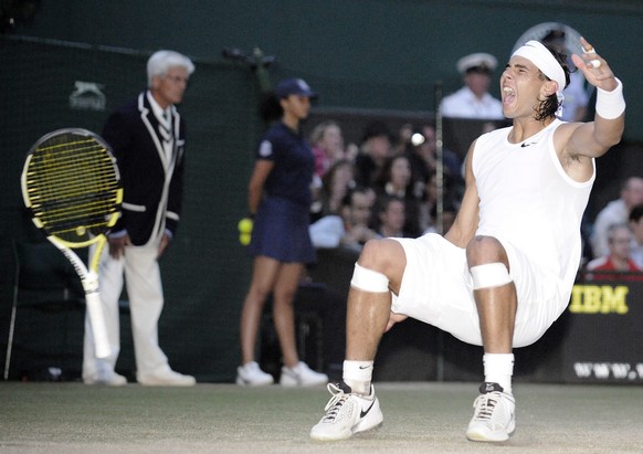 Rafael Nadal falls to the ground as he defeats Roger Federer, in the Men&#039;s Singles final on the Centre Court at Wimbledon, Sunday July 6 , 2008. (AP Photo) **UNITED KINGDOM OUT: NO SALES**