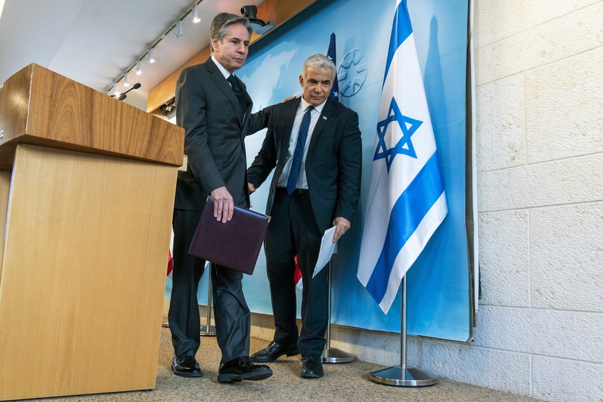 U.S. Secretary of State Antony Blinken, left, and Israel&#039;s Foreign Minister Yair Lapid walk together after a news conference, Sunday, March 27, 2022, at Israel&#039;s Ministry of Foreign Affairs  ...