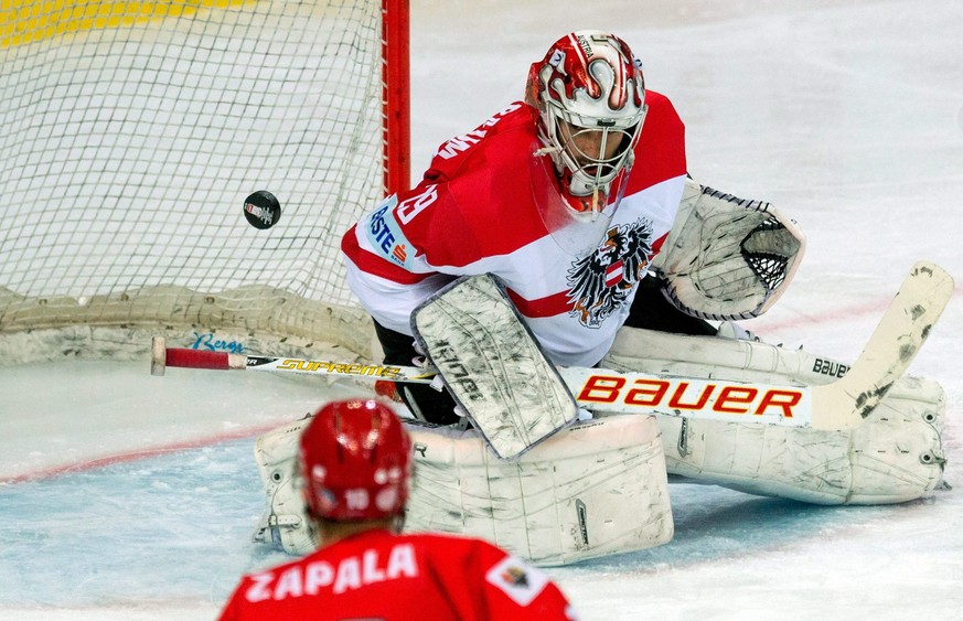 epa05280338 Krzysztof Zapala (L) of Poland and goaltender Bernhard Starkbaum (R) of Austria during the Division I Group A 2016 IIHF Ice Hockey World Championship match between Poland and Austria at Sp ...