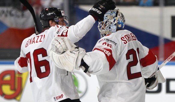 Switzerland&#039;s Niklas Schlegel, right, celebrates with teammate Joel Genazzi, left, after the Ice Hockey World Championships group B match between Czech Republic and Switzerland in the AccorHotels ...