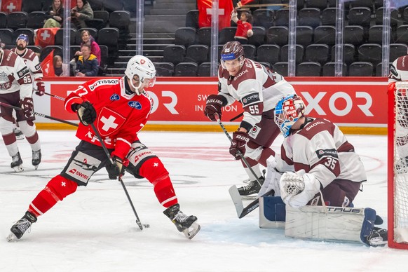 Switzerland - Latvia 26.04.2024, Lausanne, Vaudoise Arena, Road To Prague : Switzerland - Latvia. Thierry Bader Switzerland Roberts MamcicsLat and Eriks Vitols Lat during the Road to Prague Ice hockey ...