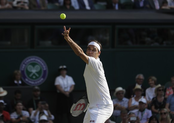 Switzerland&#039;s Roger Federer serves to Germany&#039;s Jan-Lennard Struff during their men&#039;s singles match, on the fifth day of the Wimbledon Tennis Championships in London, Friday July 6, 201 ...