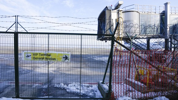 A barbed wire fence surrounds the VIP terminal at the Nikola Tesla airport in Belgrade, Serbia, Monday, Jan. 17, 2022. Novak Djokovic is expected to arrive in the Serbian capital following his deporta ...