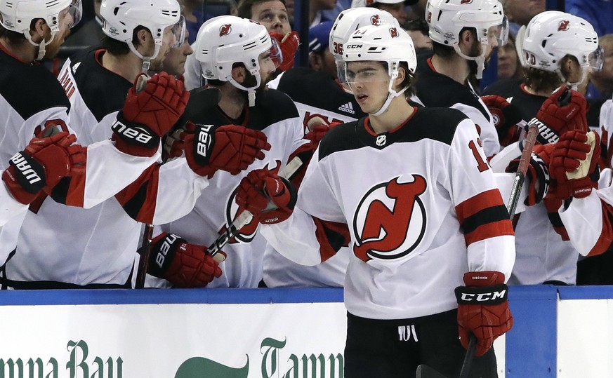 New Jersey Devils center Nico Hischier (13) celebrates his goal against the Tampa Bay Lightning with the bench during the second period of an NHL hockey game Saturday, Feb. 17, 2018, in Tampa, Fla. (A ...