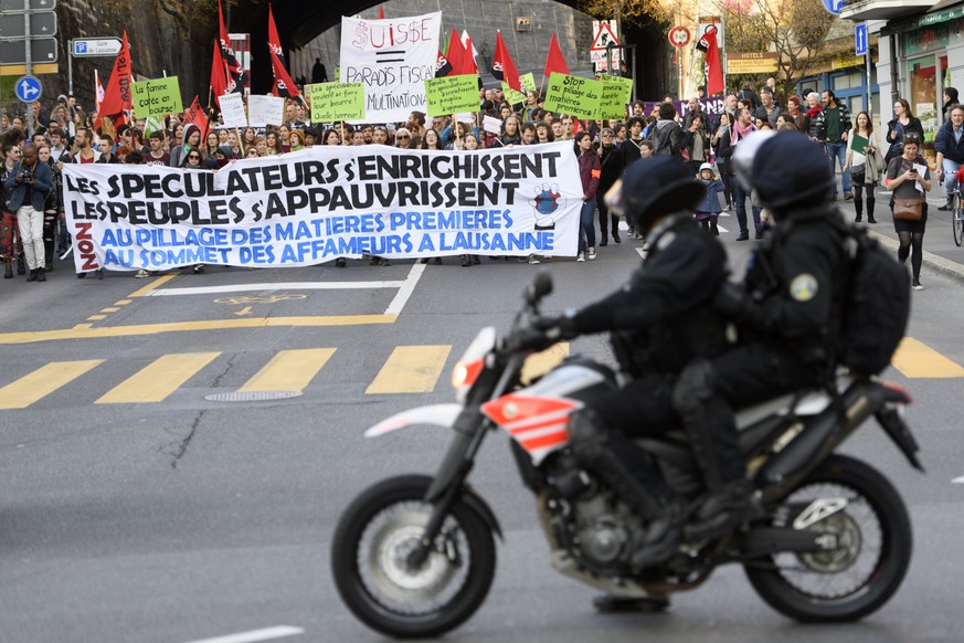 epa05874091 Participants take part in a demonstration to protest against the Financial Times Commodities Global Summit in Lausanne, Switzerland, 27 March 2017. The sixth edition of the FT global Commo ...