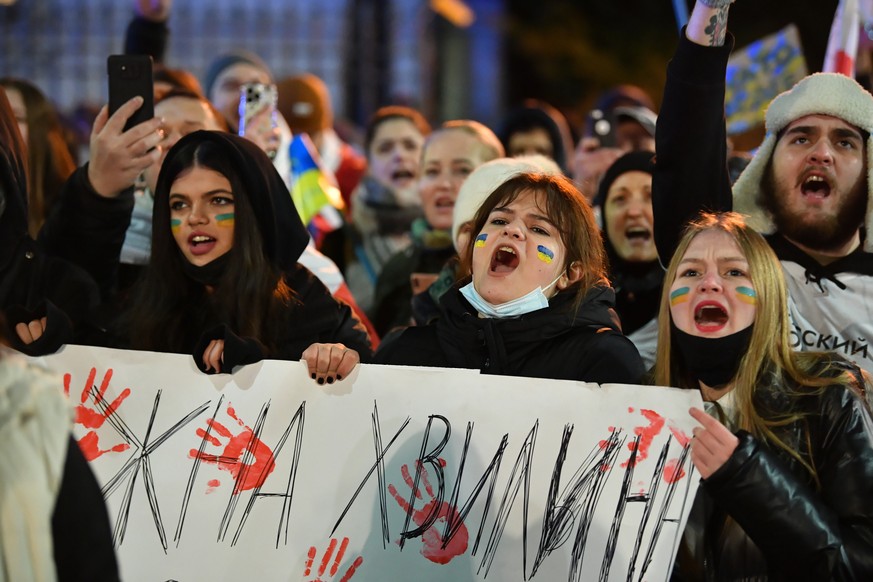 epa09789902 People demonstrate against the war in Ukraine, in front of the Russian Embassy in Warsaw, Poland, 27 February 2022. People all over the world hold vigils and demonstrations for peace in th ...