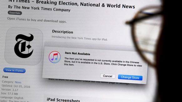 An illustration shows a person looking at a computer screen in Beijing showing an Apple iTunes store message saying that the New York Times app is not available in the Chinese store, in China, January ...