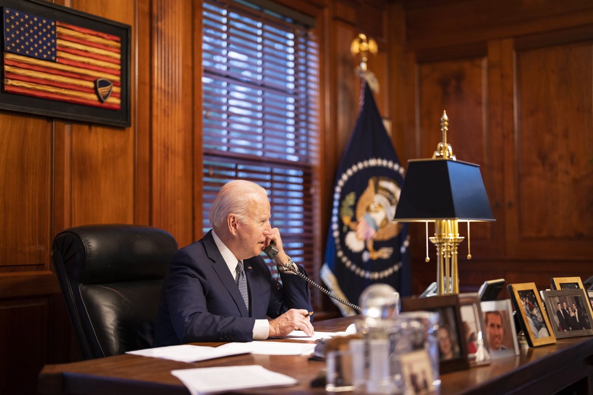 epa09660970 A handout photo made available by the White House showing US President Joe Biden speaking on the phone with Russian President Vladimir Putin on the phone from his residence in Wilmington,  ...