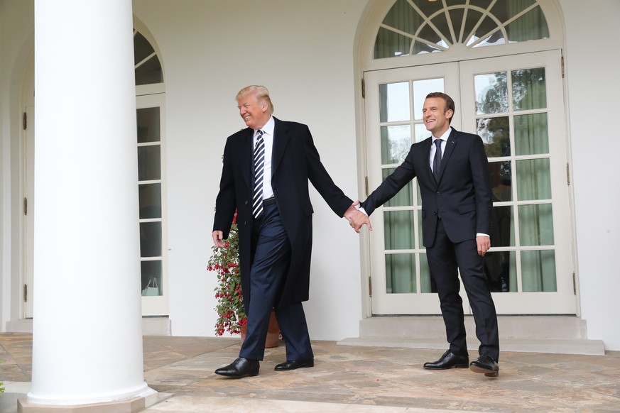 President Donald Trump and French President Emmanuel Macron walk to the Oval Office of the White House in Washington, Tuesday, April 24, 2018. Trump said the partnership he forged with Macron at the s ...